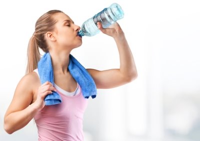 woman drinking mineral water after sport