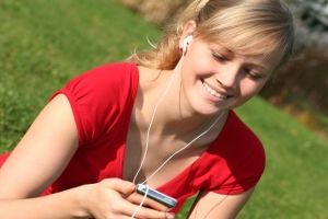 Sporty woman listening to mp3 music